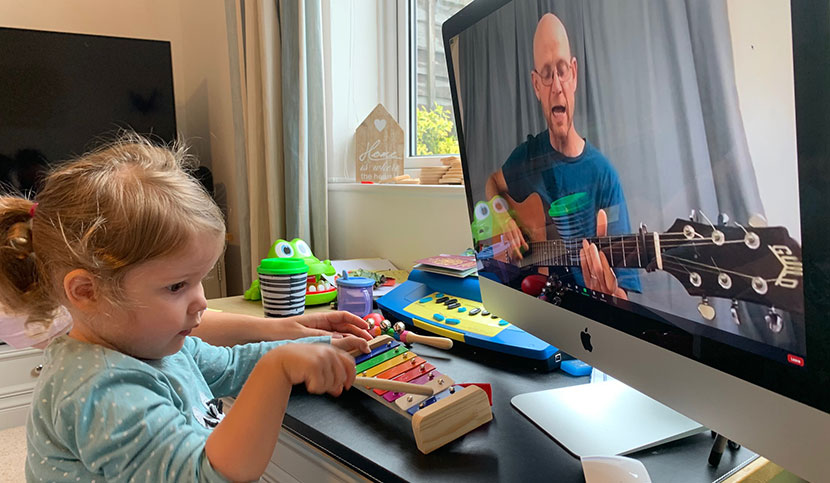child learning music from teacher on tv